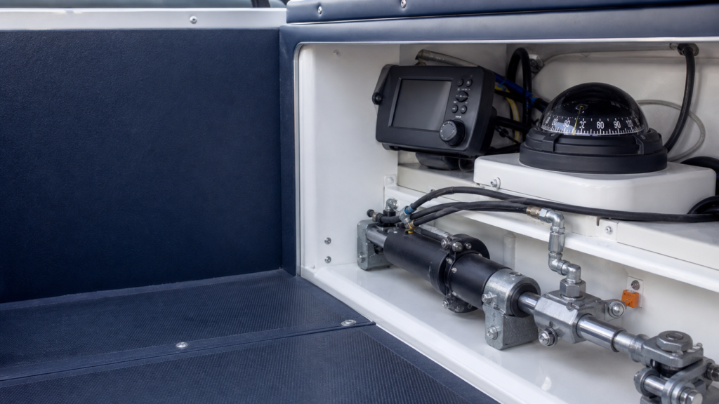 Generic marine autopilot control head and steering components arranged in a boat locker.